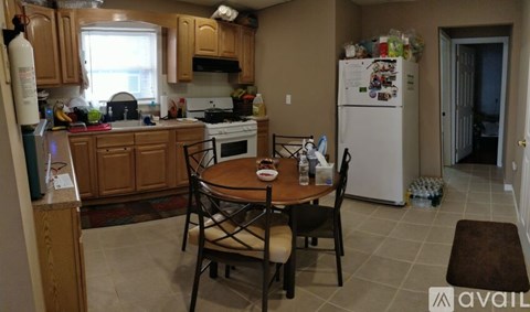 A kitchen with a table and chairs in the middle of the room.