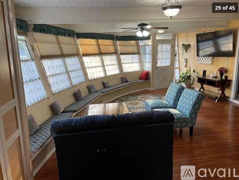 A living room with a couch and a television.