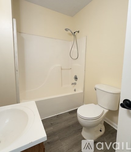A white toilet sits next to a white sink in a bathroom.