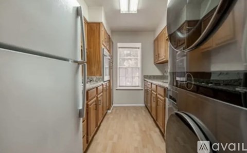 A kitchen with wooden cabinets and stainless steel appliances.