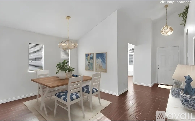 A dining room with a wooden table and chairs.