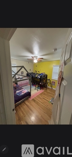 A room with a bed and a ceiling fan.