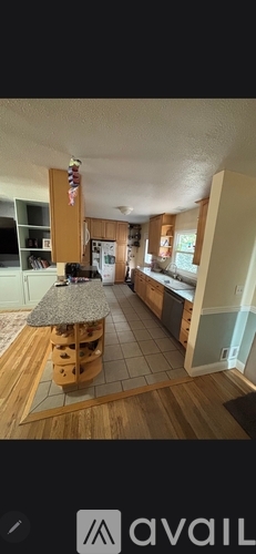 A kitchen with wooden floors and a countertop.