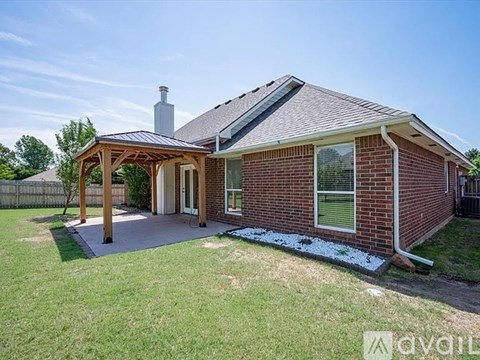 A house with a covered patio and a brick exterior.