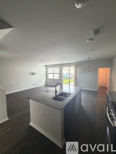 A kitchen with a sink and a window.