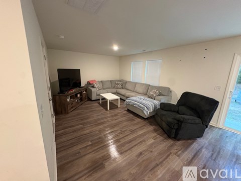 A room with a carpeted floor and a window letting in light.