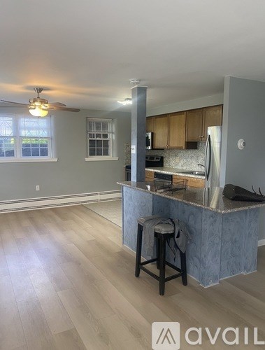 A kitchen with a bar stool in front of a counter.