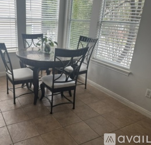 A dining table with chairs around it in a room.