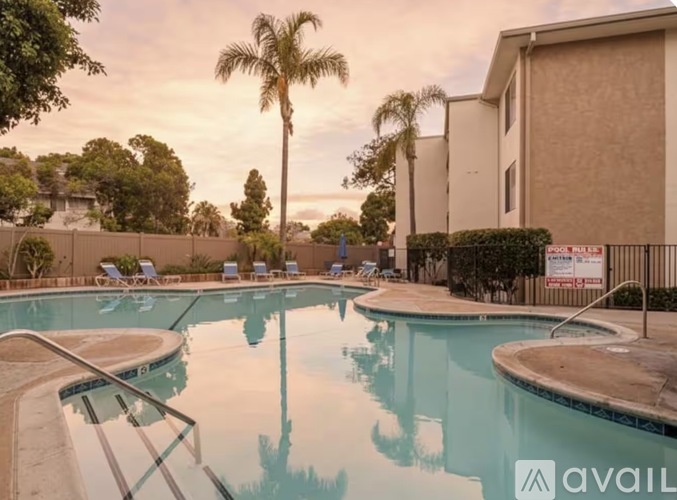 A pool with a glass barrier and a sign that says "available" in the background.
