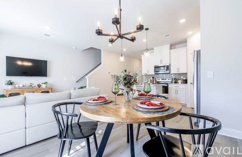 A modern dining room with a round table set for two.