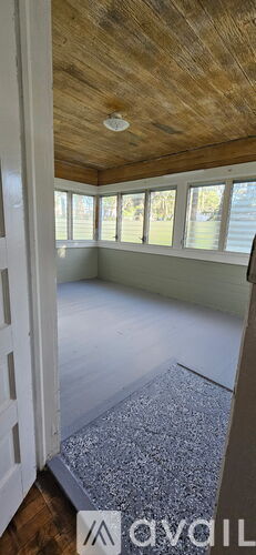 A room with a wooden ceiling and a window.