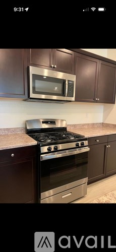 A kitchen with a stove and microwave.