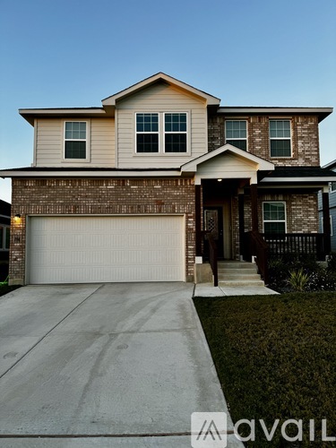 A two-story house with a garage is shown in the image.