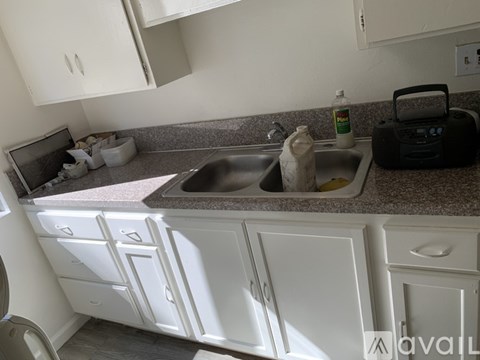 A kitchen with a sink and a dishwasher.