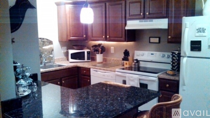 A kitchen with a black granite counter top.