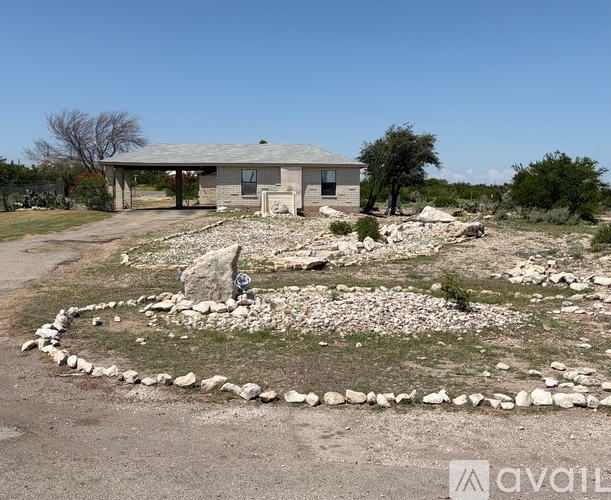 A house with a stone pathway in front of it.