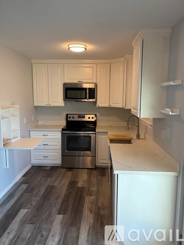 A kitchen with a stove top oven and microwave above it.