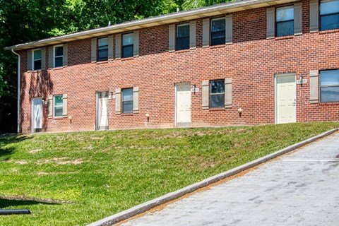 A red brick building with white doors and windows.