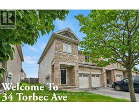 A house with the text "Welcome To 34 Torbec Ave" in front of it.