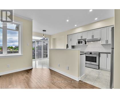 A kitchen with white cabinets and a stove top oven.