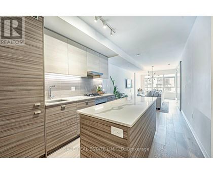 A modern kitchen with wooden cabinets and a white countertop.