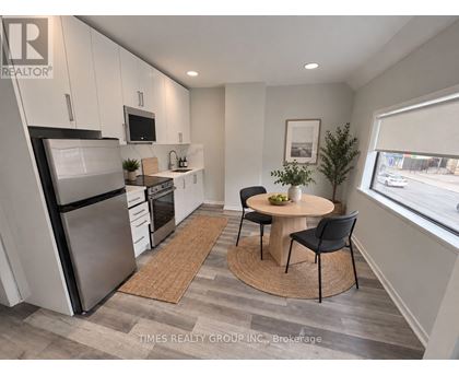 A modern kitchen with a dining table and chairs.