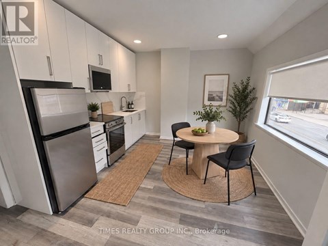 A modern kitchen with a dining table and chairs.