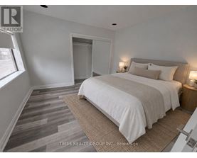 A bedroom with a large bed and a carpeted floor.