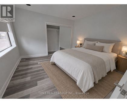 A bedroom with a large bed and a carpeted floor.