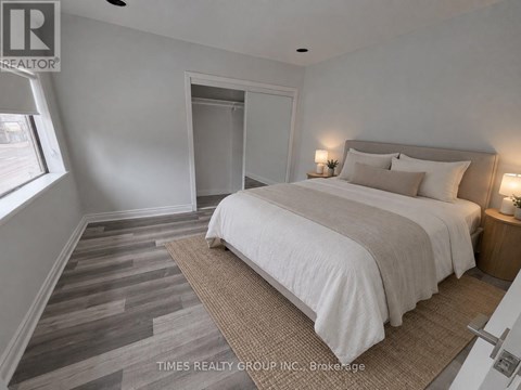 A bedroom with a large bed and a carpeted floor.