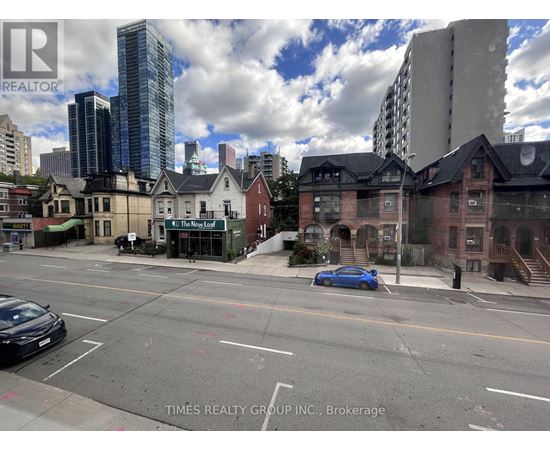 A city street with a blue car parked on the side.