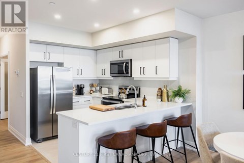 A modern kitchen with white cabinets and a large island.