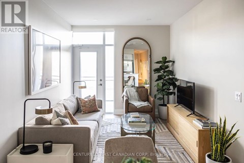 A living room with a couch, chair, and television.