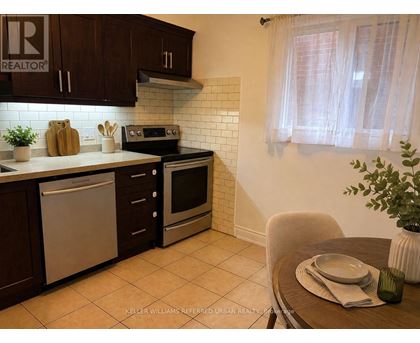A kitchen with a dining table and chairs.