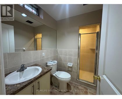 A bathroom with a sink, toilet, and shower.