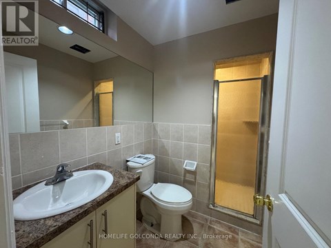 A bathroom with a sink, toilet, and shower.