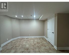 A room with a carpeted floor and a door on the right side.