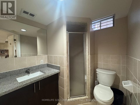 A bathroom with a toilet, sink, and shower.