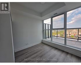 A room with a large window overlooking a residential area.