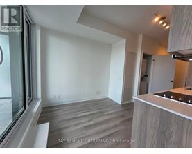 A modern kitchen with a wooden floor and white walls.