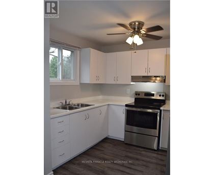 A kitchen with white cabinets and a stainless steel oven.