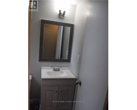 A bathroom with a sink and a mirror.