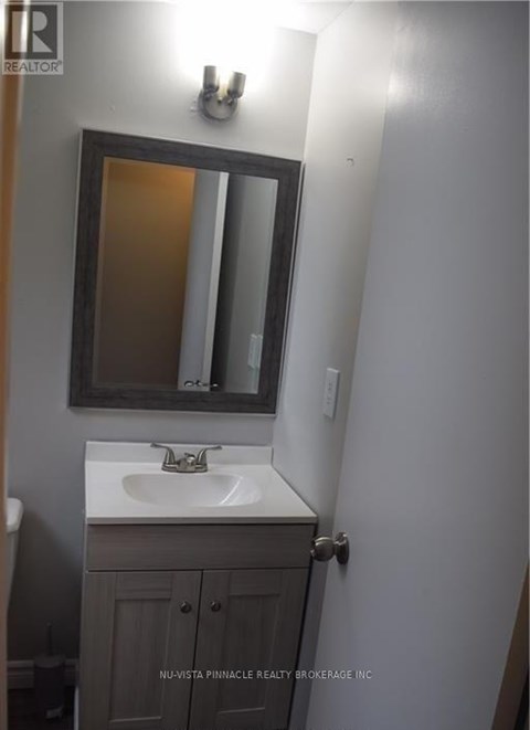 A bathroom with a sink and a mirror.