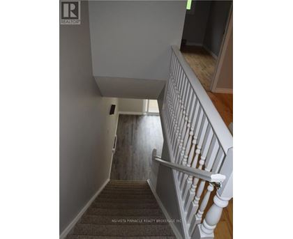 A staircase with a white railing and wooden steps.