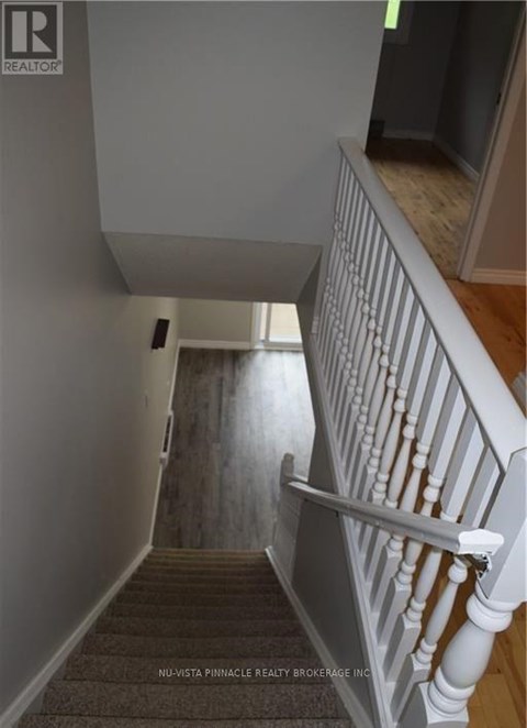 A staircase with a white railing and wooden steps.