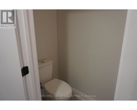 A small white toilet in a small bathroom.