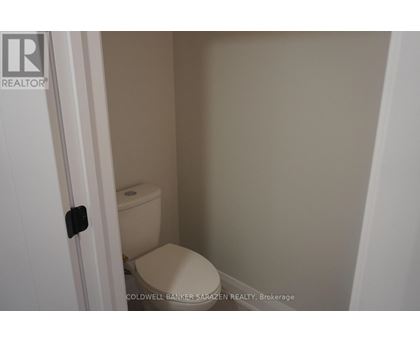 A small white toilet in a small bathroom.