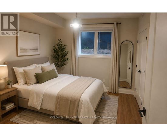 A well-lit bedroom with a large bed and a small tree.