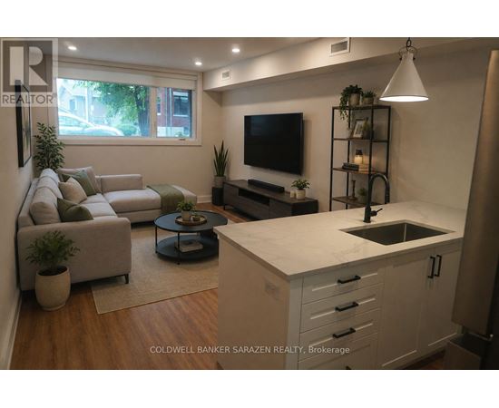 A modern kitchen with a white countertop and a flat screen TV mounted above it.