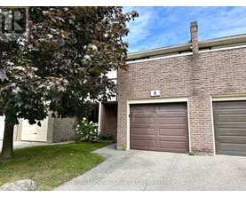 A house with a brown garage door is for sale.